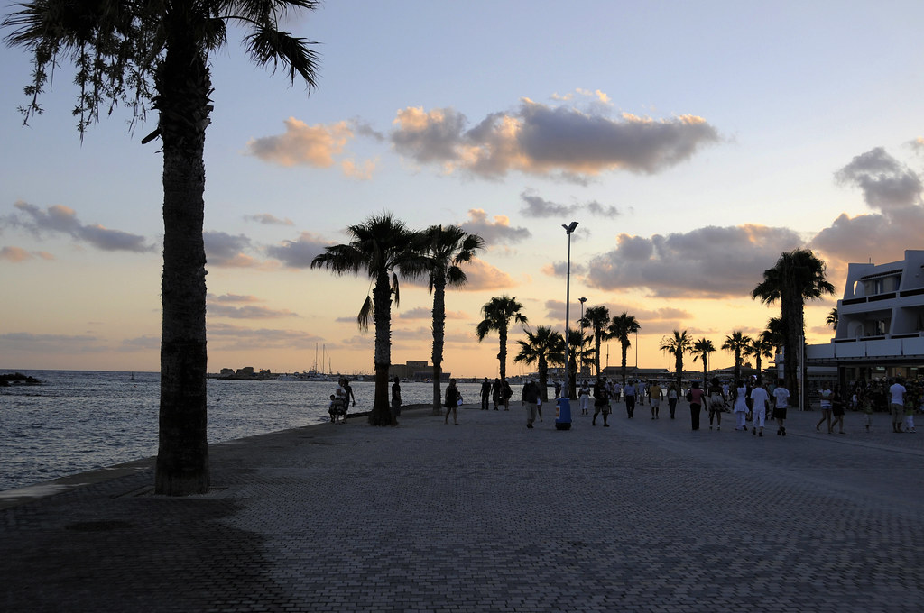 Paphos harbour at sunset with boats and waterfront buildings in Cyprus