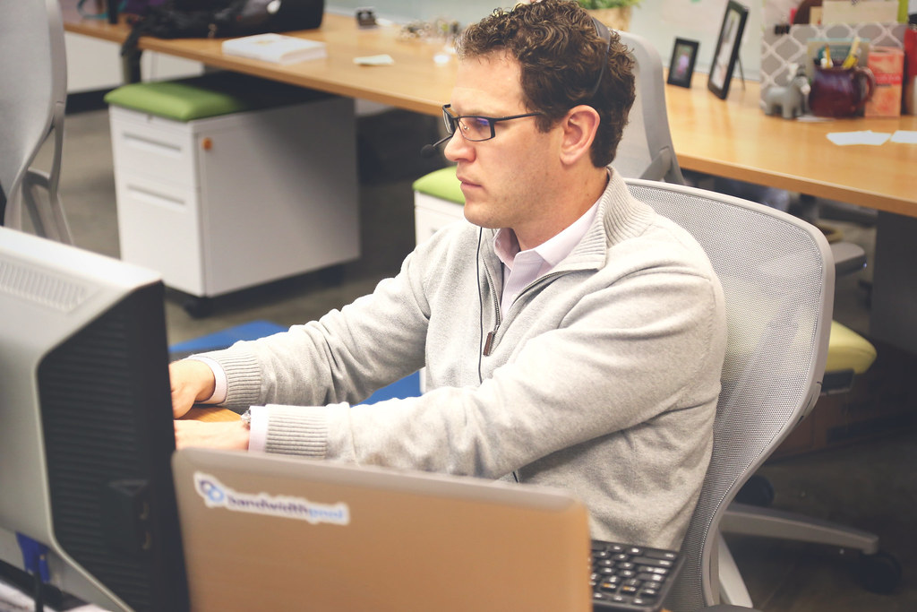 A bright coworking desk with laptop, notebook and coffee — flexible workspace